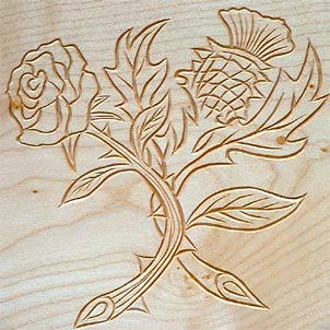 Closeup of thistle and rose centre engraving.